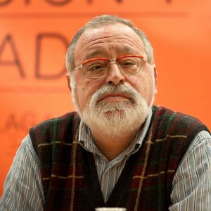 man in black and white striped dress shirt wearing eyeglasses